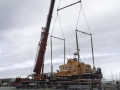 Mobile crane lifting boat.